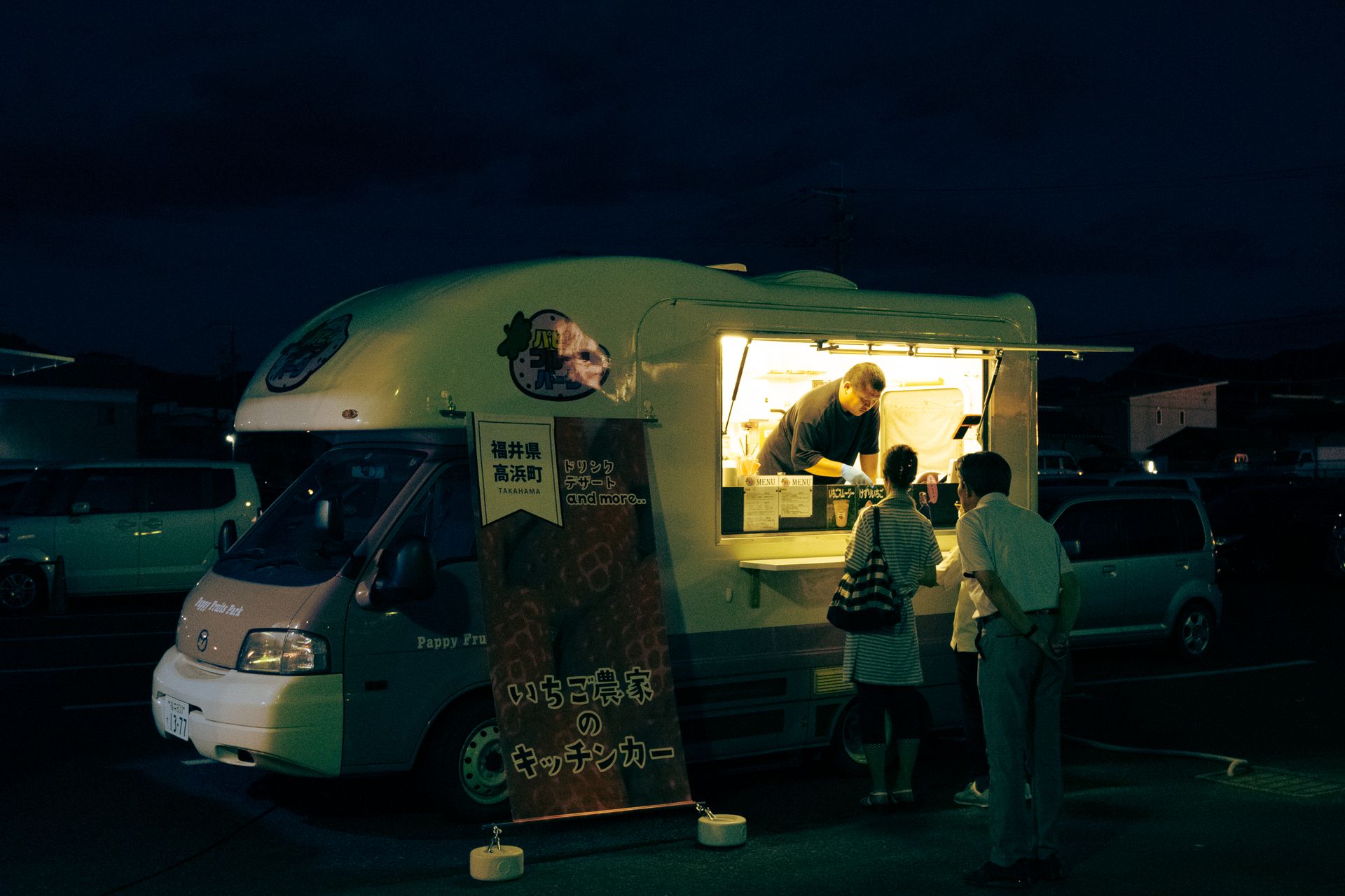 Food truck serving customers at night